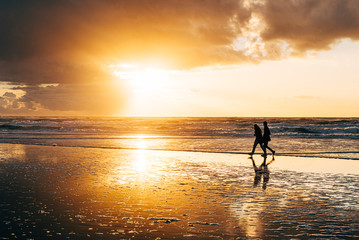 silhouette of a couple at sunset at beach