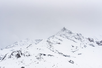 Fototapeta na wymiar Mountain top with snow and clouds 