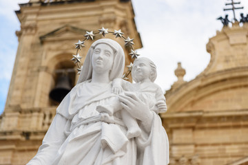 Fototapeta premium Statue of the Virgin Mary with child Jesus outside the Parish Church in Xaghra, Gozo, Malta.