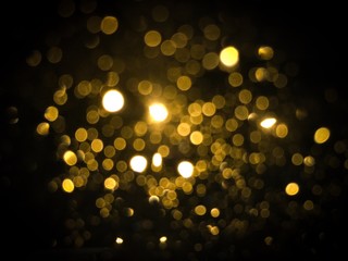 Gold light abstract bokeh on black background