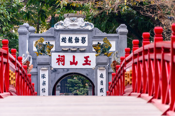 The iconic red painted Huc Bridge over Ho Hoan Kiem Lake, Hanoi, Vietnam which leads to the Den Ngoc Son Confucious Temple.