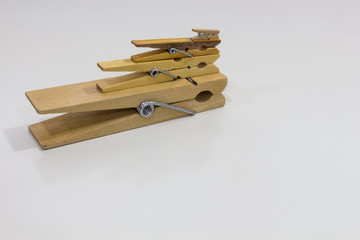 Different types of wooden clothespins on white table