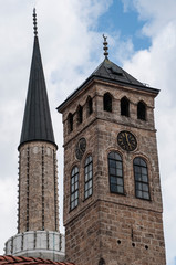Fototapeta na wymiar Sarajevo, Bosnia: Sarajevska Sahat Kula, the Clock Tower built by Gazi Husrev-beg, governor in the Ottoman period, and the minaret of Gazi Husrev-beg Mosque (1532) in the Bascarsija neighborhood