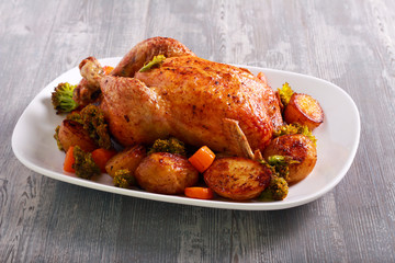 Roast chicken with potatoes and broccoli