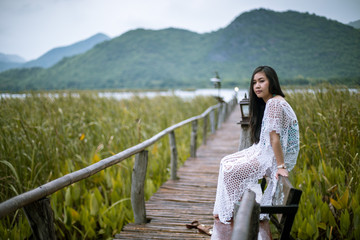 Fototapeta premium Woman sitting on a pier