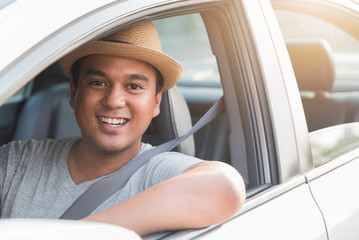 Young handsome asian man driving car with copy space.