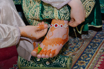 Henna being applied on bride's hand