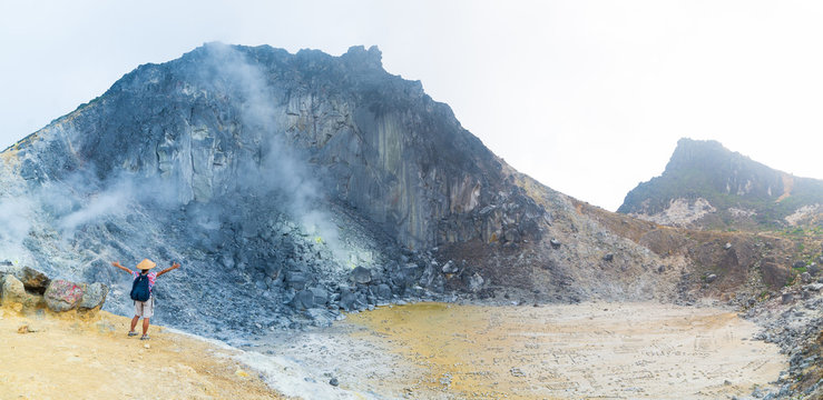 Sibayak volcano, active caldera steaming, famous travel destination natural landmark and tourist attraction in Berastagi Sumatra Indonesia. Tourist looking at view from the top, traveling people.