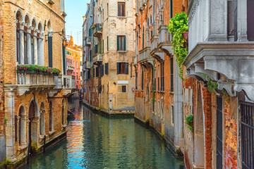 Venetian canal with gondola and colorful facades of old medieval houses in Venice, Italy - obrazy, fototapety, plakaty