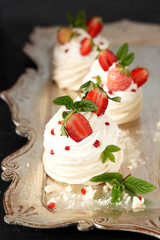 Pavlova dessert - merengue with patisserie , whipped cream and strawberries on top