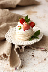 Pavlova dessert - merengue with patisserie , whipped cream and strawberries on top
