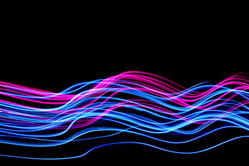 Long exposure, light painting photography.  Vibrant electric blue streaks and ripples of neon pink,...