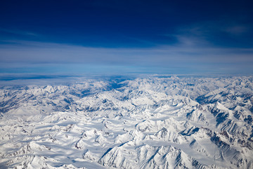 Fototapeta premium Aerial view from top of Himalayan mountains from the airplane window with Snow cover all of mountain range. Surface of white on peak hill over sky in Leh Ladakh, India.