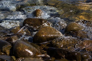 Smooth stones in the wave of the Sea, background