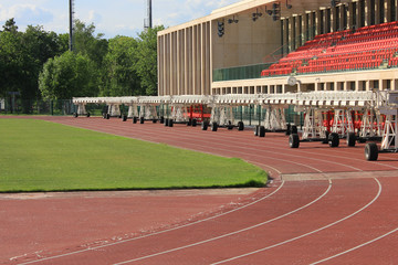Football stadium with grass field and bleachers 