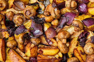 Potato, mushrooms and onion baked in oven, top view.