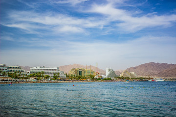 Fototapeta premium waterfront panorama of Israeli city Eilat harbor picturesque and bright touristic destination for summer vacation in Middle East district on a Red sea 