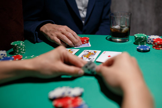 Poker Aces pair .green poker table with top pair. casino gambling. playing cards close-up. poker player watching his hand