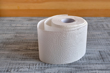 roll of toilet paper on a wooden background