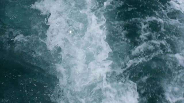 Abstract slow motion water ocean waves texture background. surface of sea wave splash and foam.