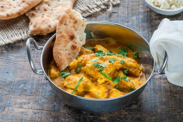 Chicken korma curry with naan bread - high angle view