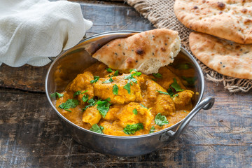 Chicken korma curry with naan bread - high angle view