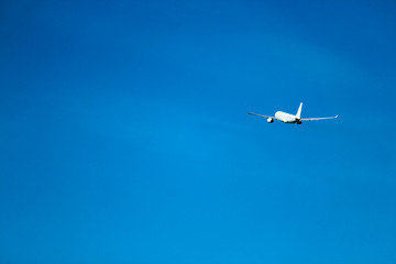 Flight to vacation airplane in the bright blue sky after takeoff