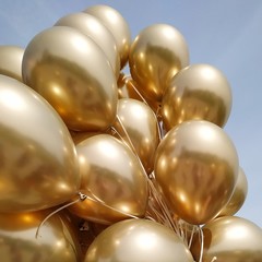 holidays, birthday party, wedding decoration concept - many metallic gold helium balloons on blue...