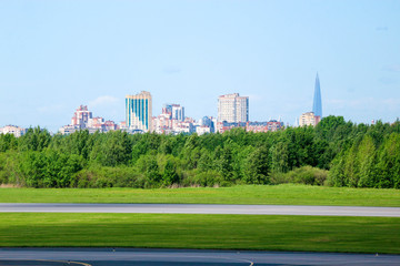 view of Saint Petersburg city silhouette from Pulkovo airport with runway and forest on the...