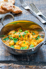 Chicken korma curry with naan bread - high angle view