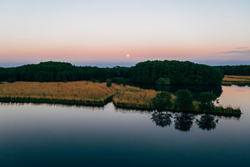 Naklejka na ściany i meble Aerial shot of the fishing ponds after sunset, southern Poland. 