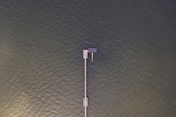 Aerial topdown view of the end of the pier on the sea. 