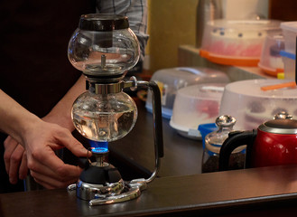 Barista making coffee using special glass jar