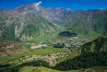 Aerial view of Gergeti and Stepantsminda towns with Mount Shani on background, Greater Caucasus Range, Georgia