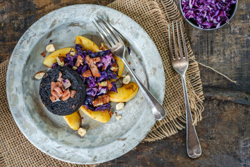 Warm salad of red cabbage, black pudding and apple with crispy bacon and crushed hazelnuts -...