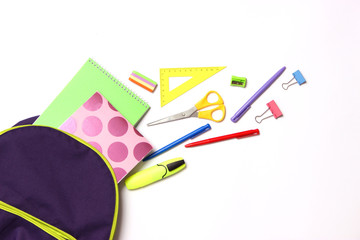 school backpack and school stationery on a light background top view. Concept back to school.