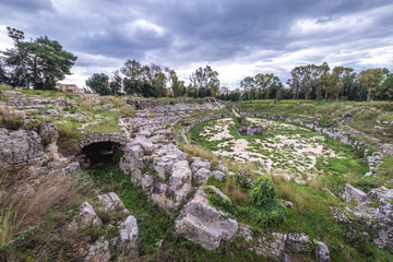 Ancient ruins of Roman Amphitheater in Archaeological Park in Syracuse, Sicily, Italy