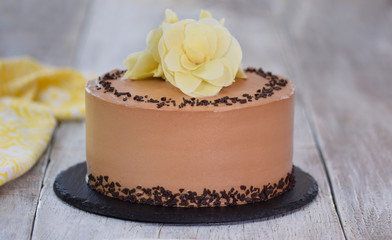 Chocolate cake decorated with white flowers