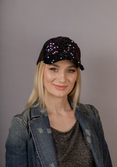 Beautiful girl with natural make-up in a headdress on a gray background.