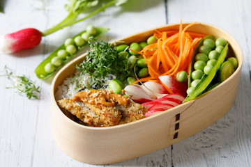 Japanese style bento lunch box with chicken, rice and vegetables