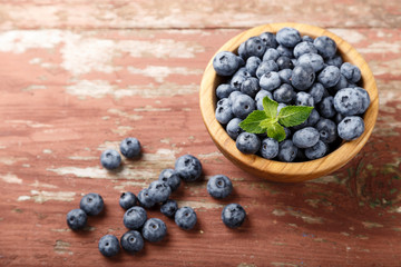 blueberries in a brown wooden plate