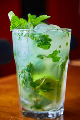 Summer fresh classic mojito with mint and lime garnish on bar top in restaurant 