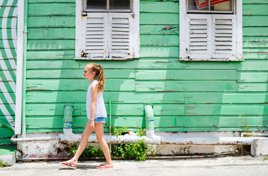 Little girl against colorful wall