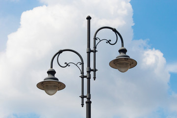 retro street lamp against a cloudy sky