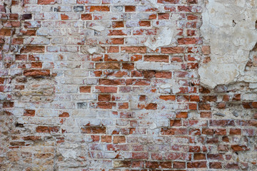 antique red brick wall with crumbling stucco