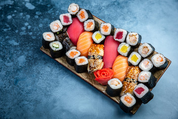 Set of sushi and maki on stone table. Top view with copy space