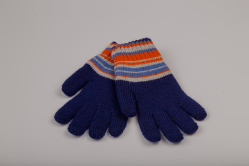 Children's winter gloves on a white background.