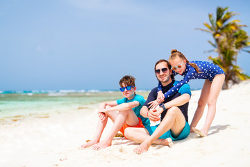 Father with kids at beach