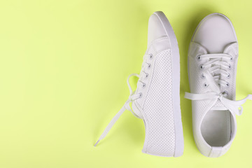 white sneakers on color background. copy space.