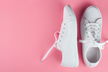 white sneakers on color background. copy space.